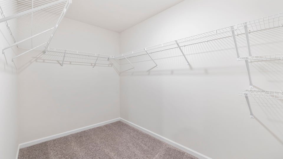 Primary bedroom walk-in closet.