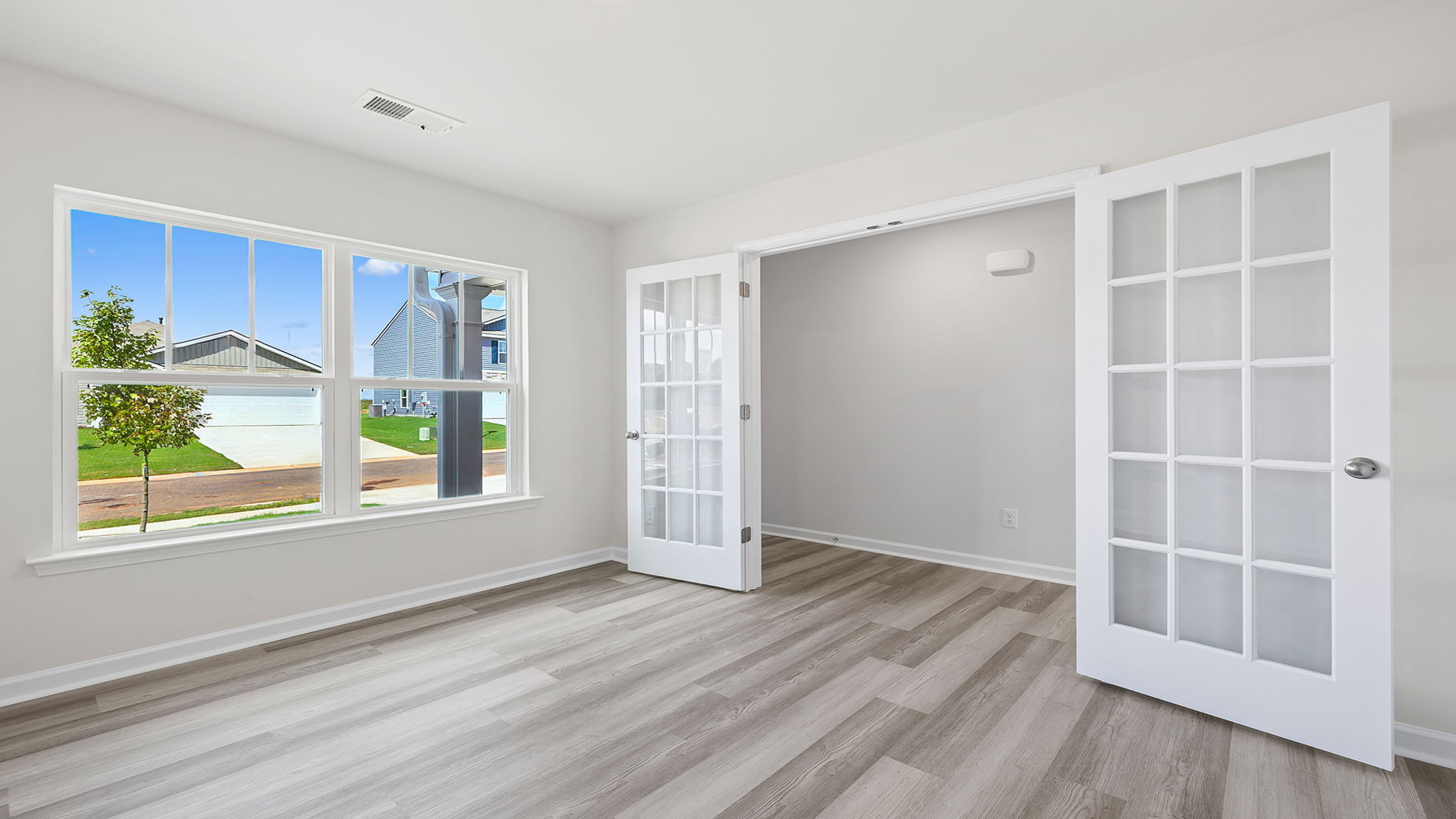 Study with large window and French doors.