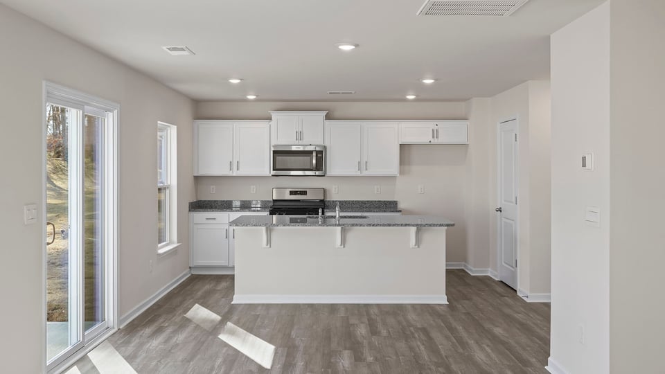 Kitchen with island and cabinets.