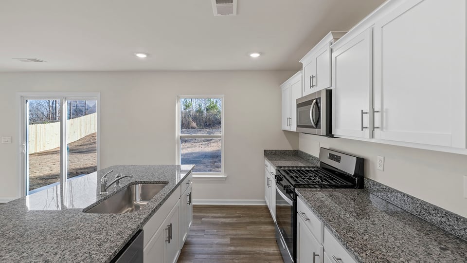 Kitchen with island and cabinets.