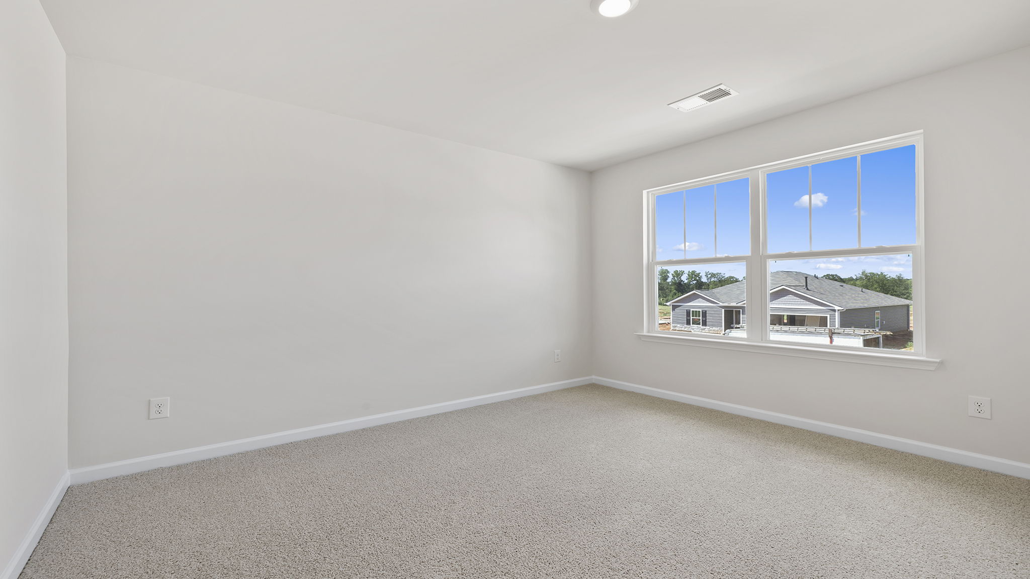 Bedroom with window and carpet.