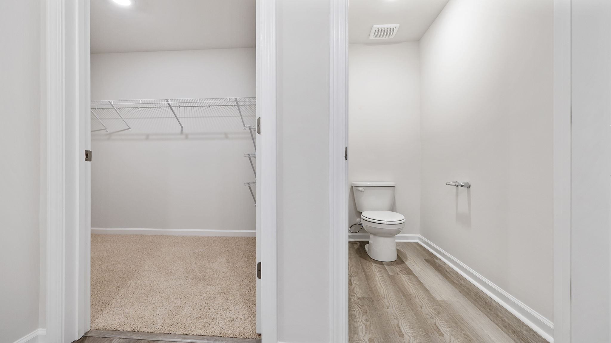 View of toilet area and walk-in closet.