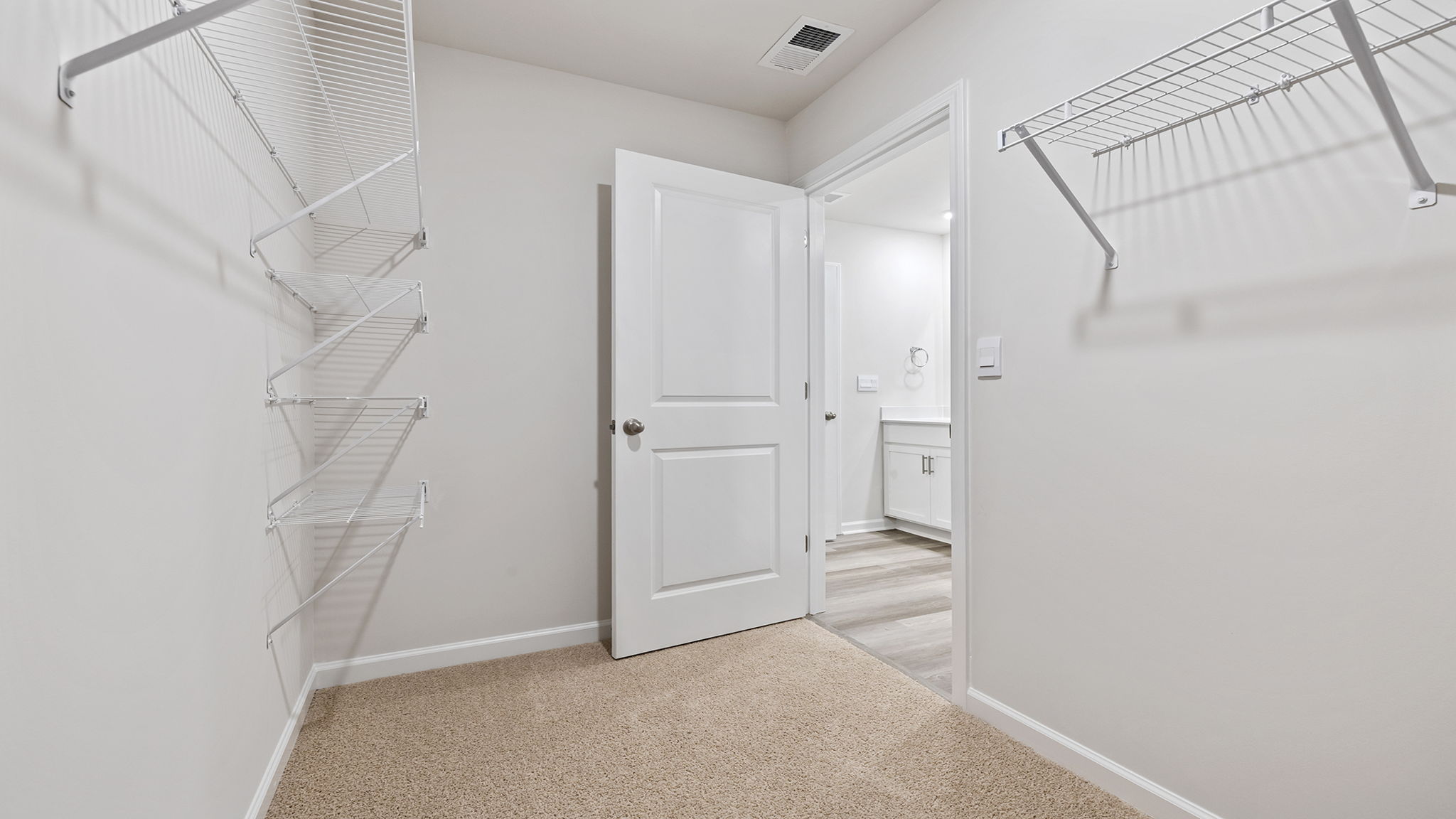 Primary bedroom walk-in closet.