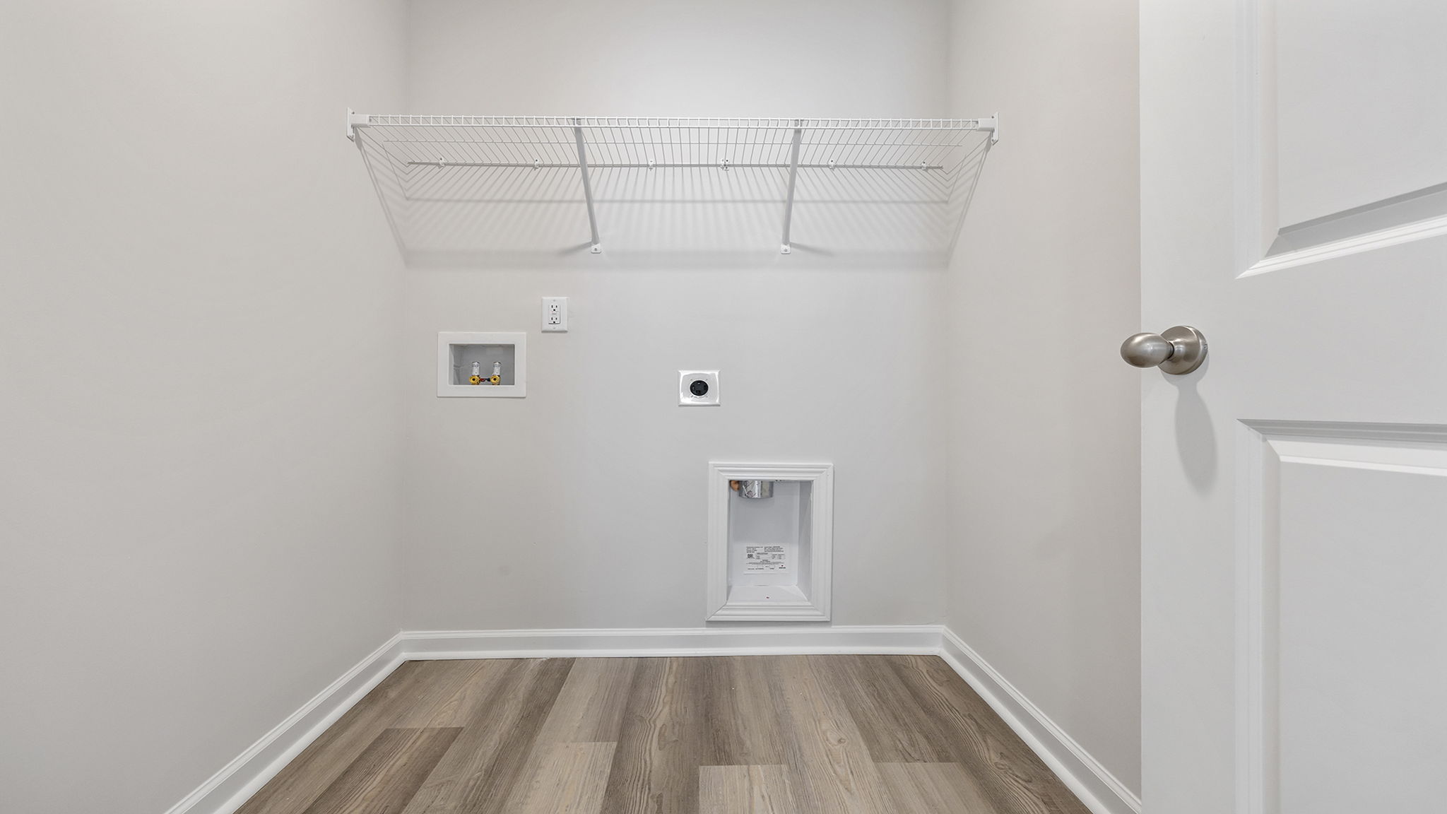 Laundry room with shelving.