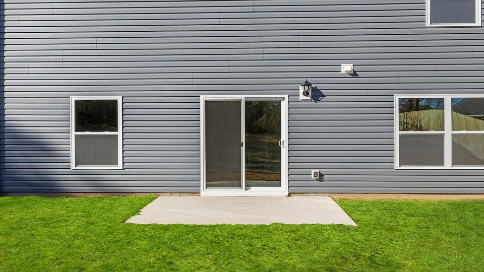 Back exterior of the Belhaven with patio.