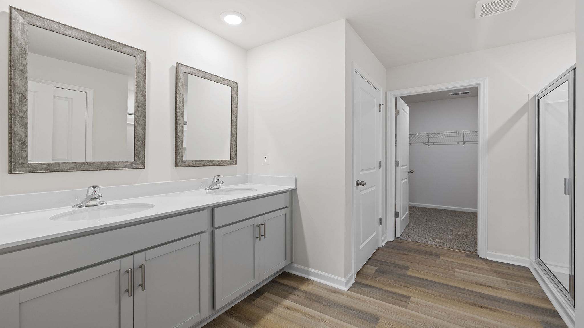 Primary bathroom with dual sink vanity;