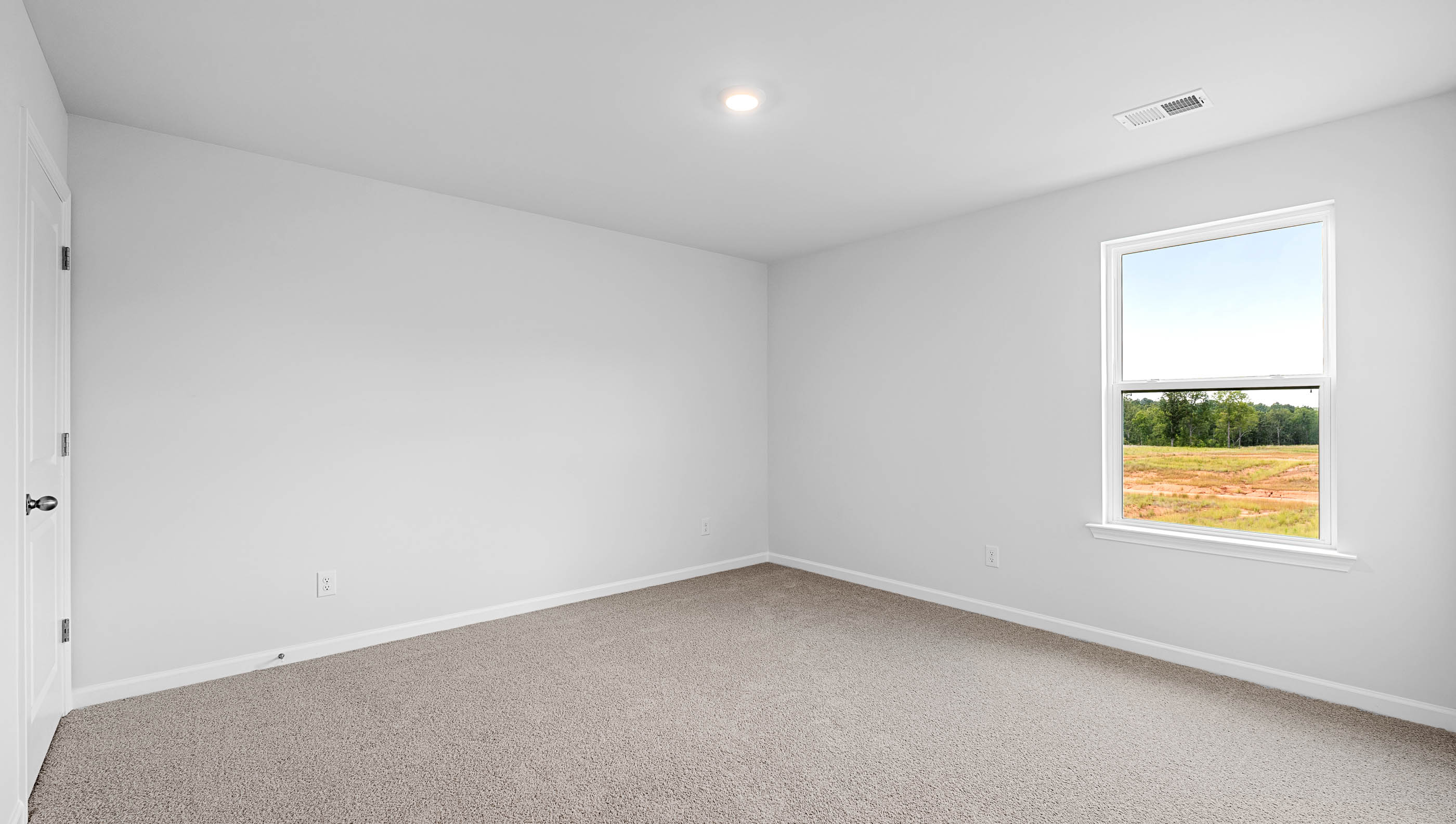 Bedroom with window and carpet.
