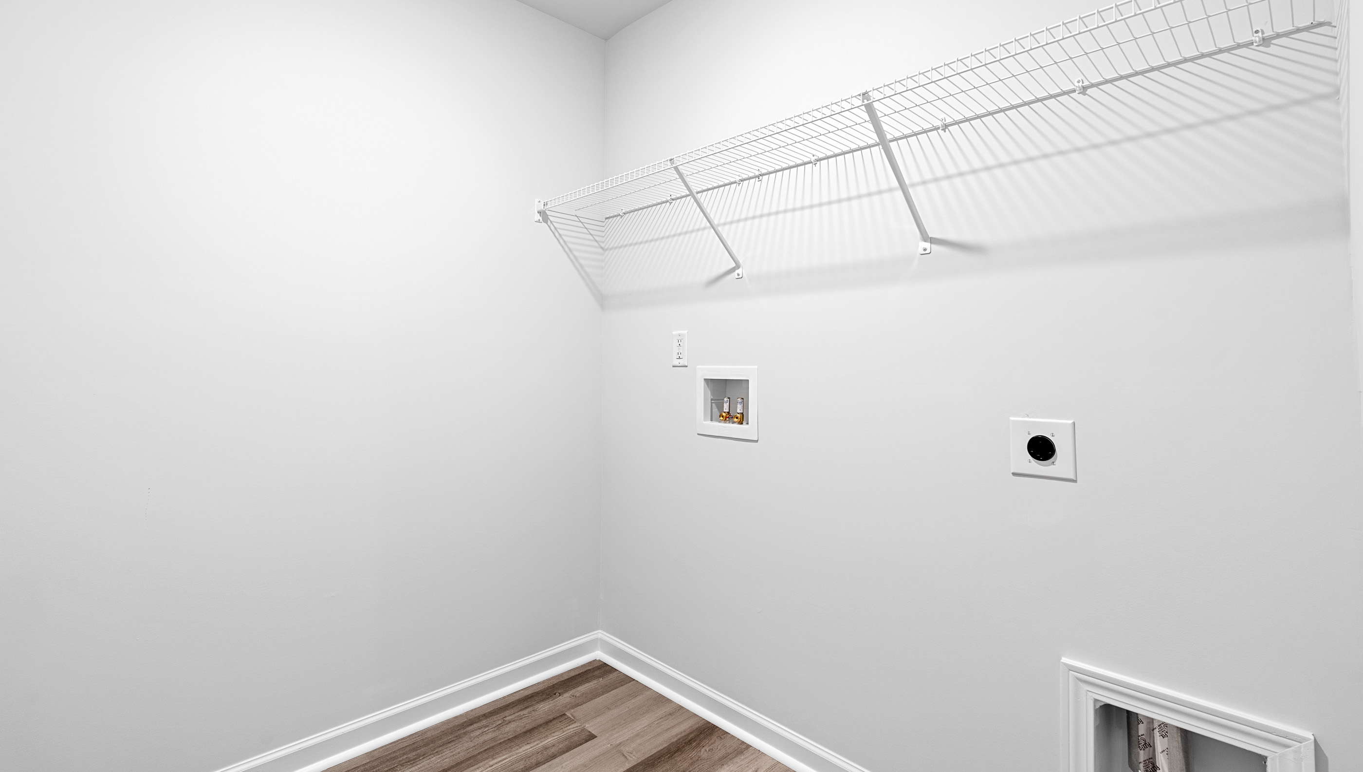 Walk-in laundry room with shelving.