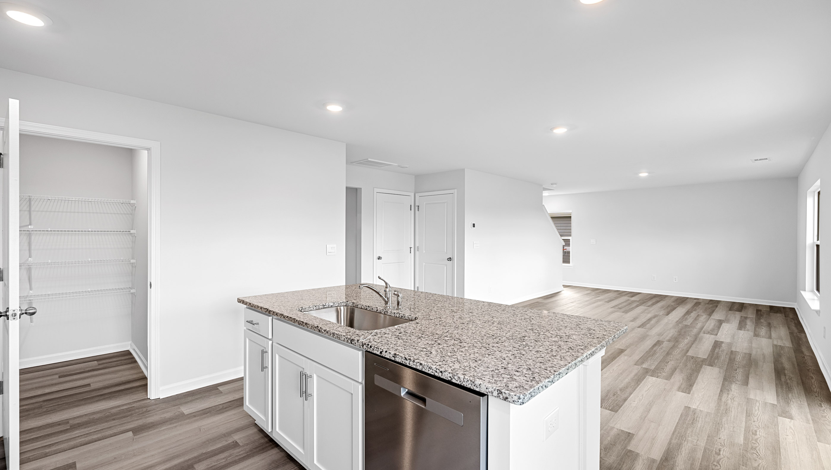 Kitchen island hosts sink and dishwasher.