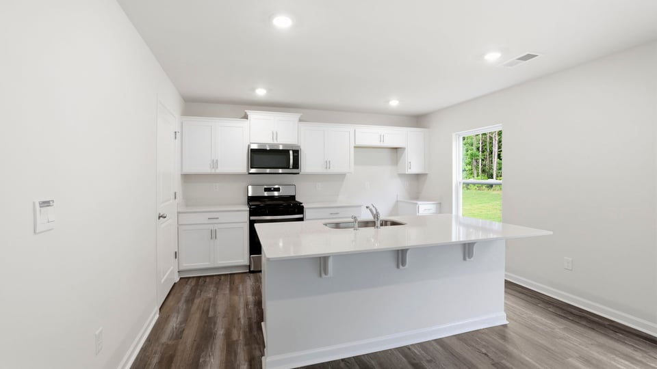 Kitchen and island with quartz countertops.a