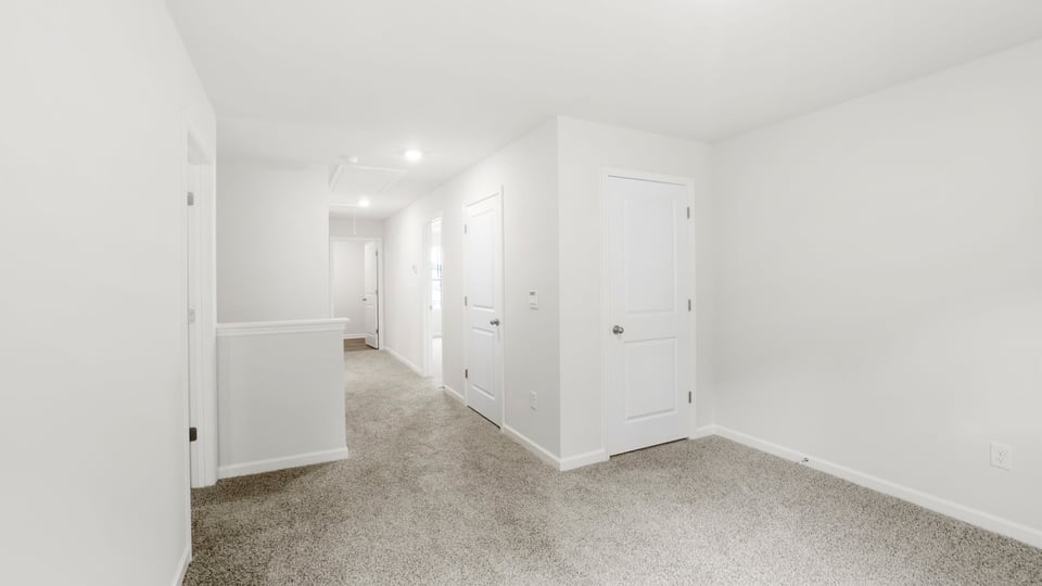 Loft area with carpet.