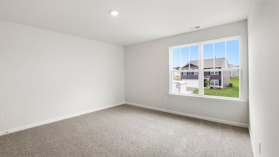 Bedroom with carpet and window.