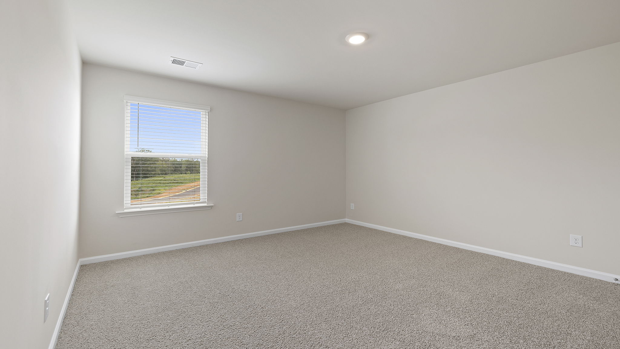 Bedroom with carpet and window.