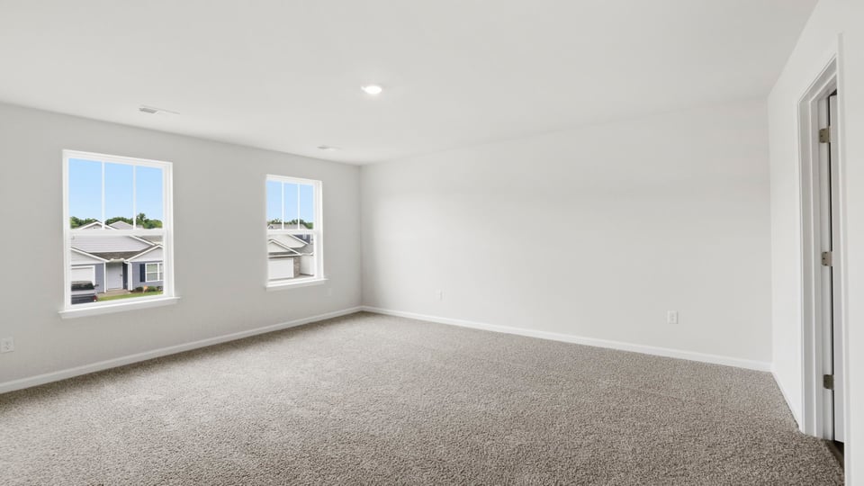 Bedroom with carpet and window.