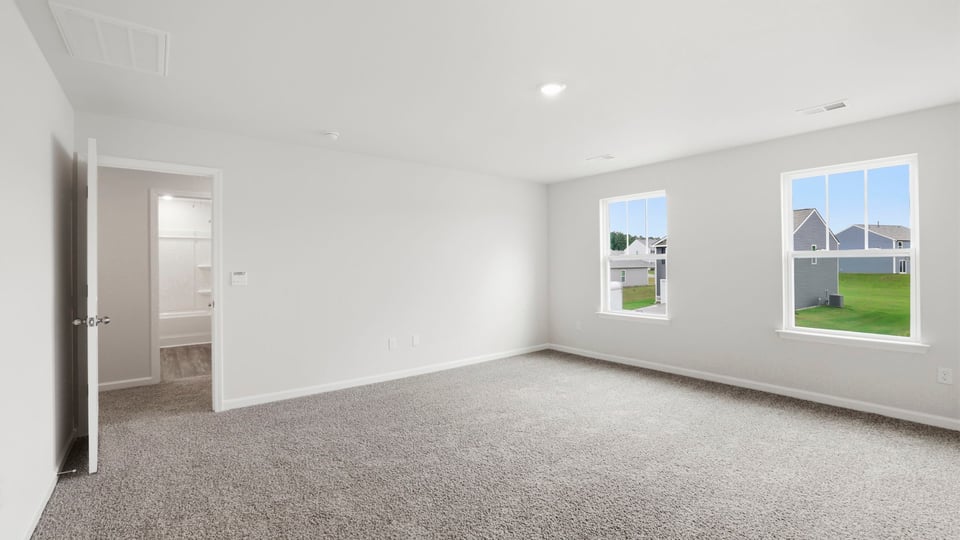 Bedroom with carpet and window.