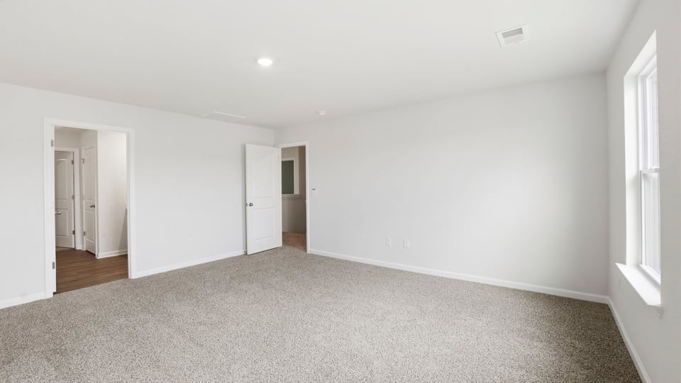 Bedroom with carpet and window.
