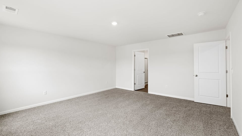 Bedroom with carpet and window.