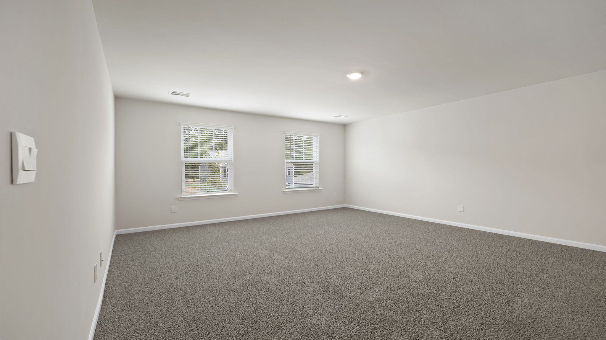 Bedroom with carpet and window.