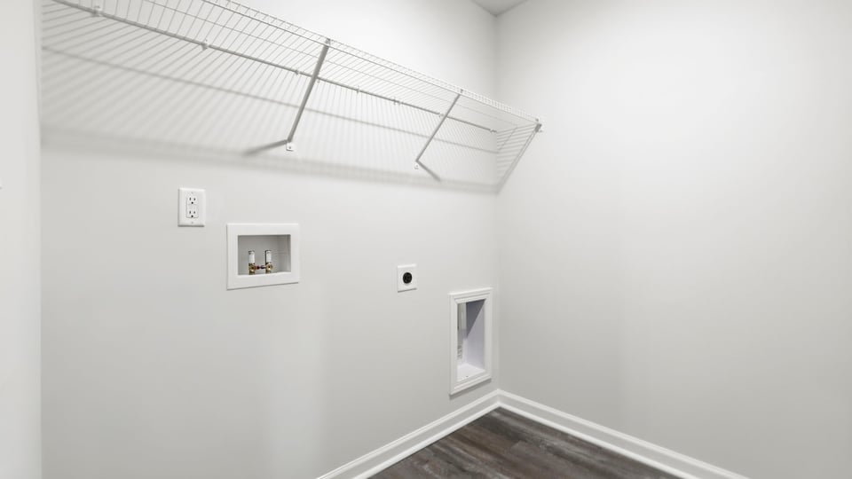 Laundry room with hanging storage racks.