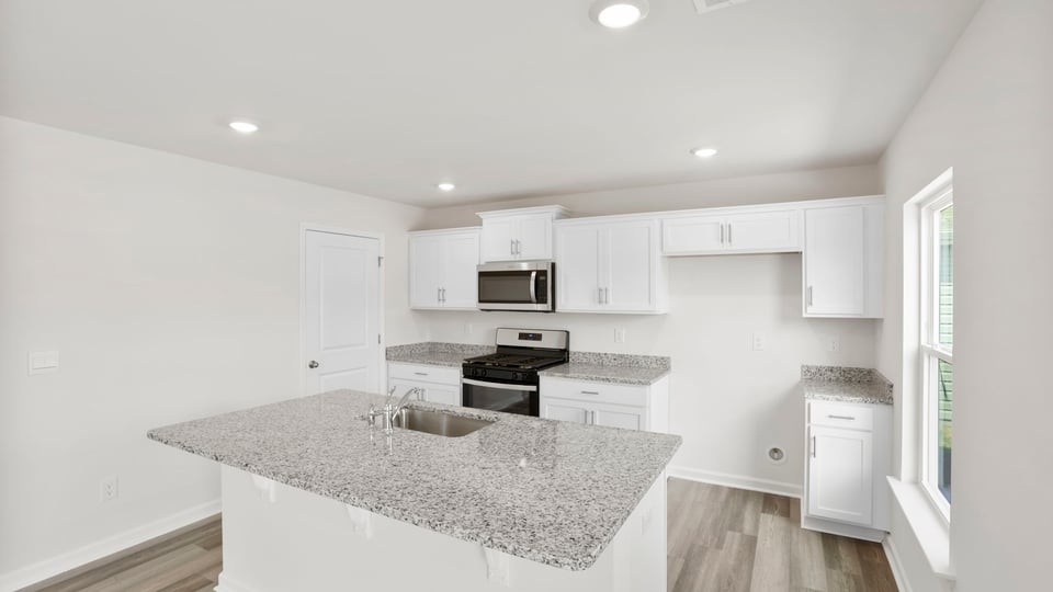 Kitchen with island and cabinets.