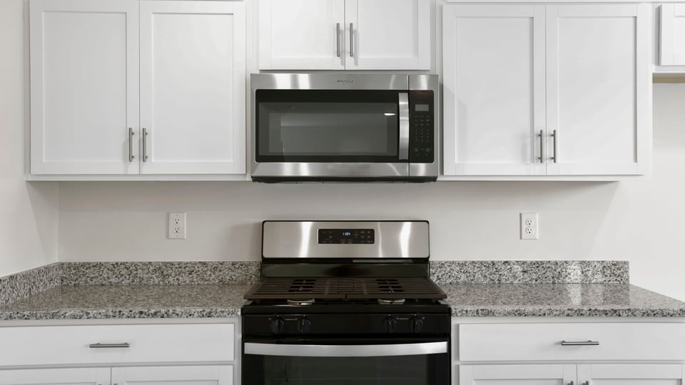Kitchen with island and cabinets.