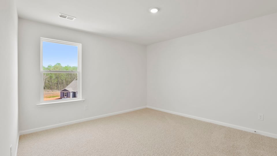 Bedroom with carpet and windows.