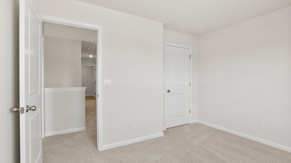 Bedroom with carpet and windows.