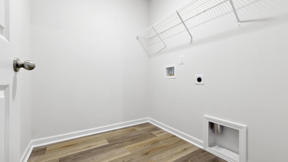 Laundry room with shelf.