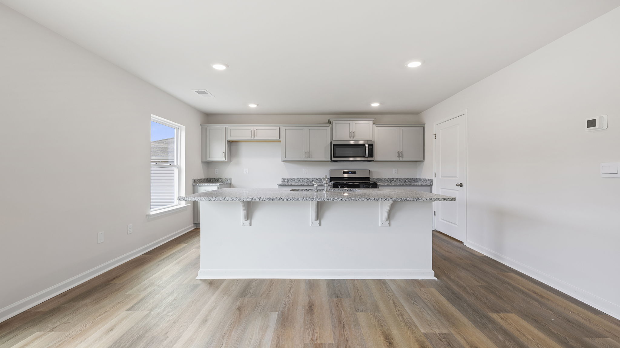 Kitchen with island and quartz countertops.