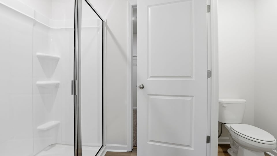 Primary bathroom with walk-in shower and water closet.