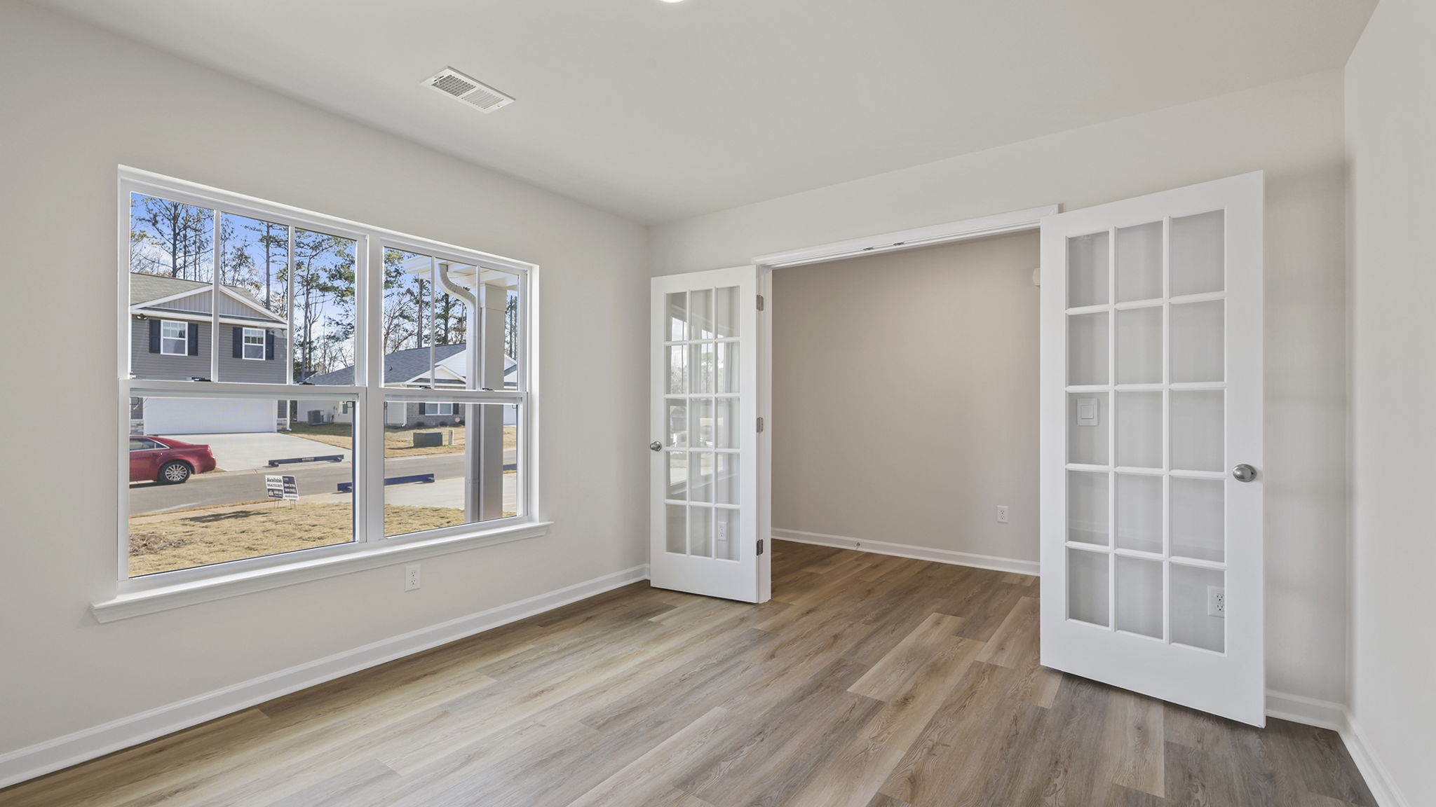Study with windows and accented by French doors.