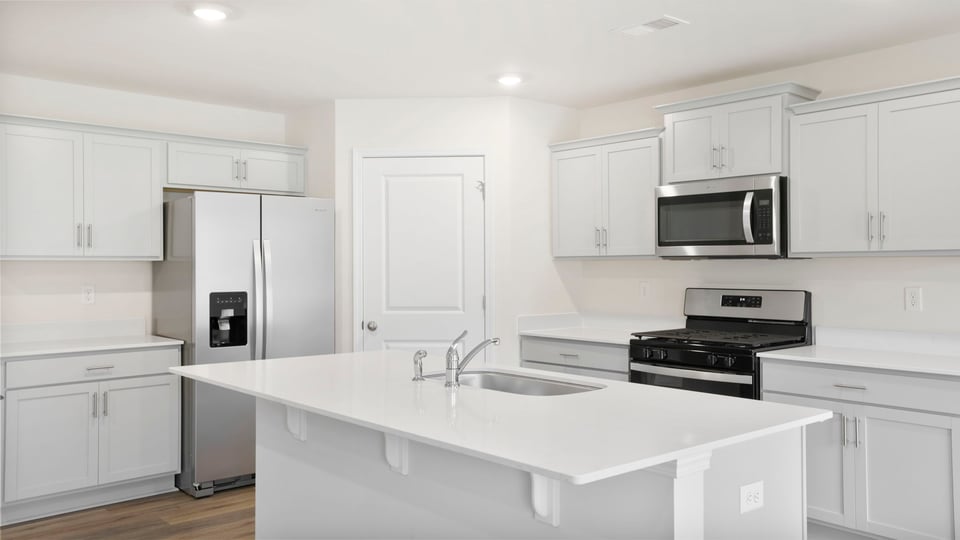 Kitchen and island with quartz countertops.