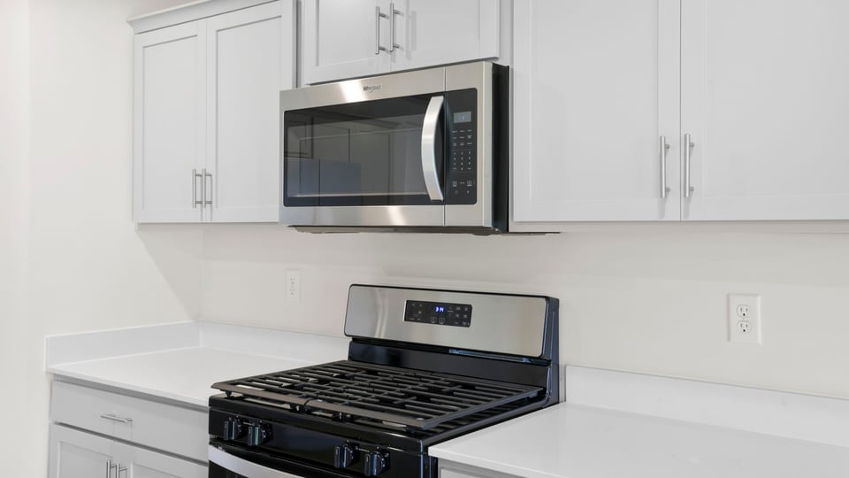 Kitchen and island with quartz countertops.