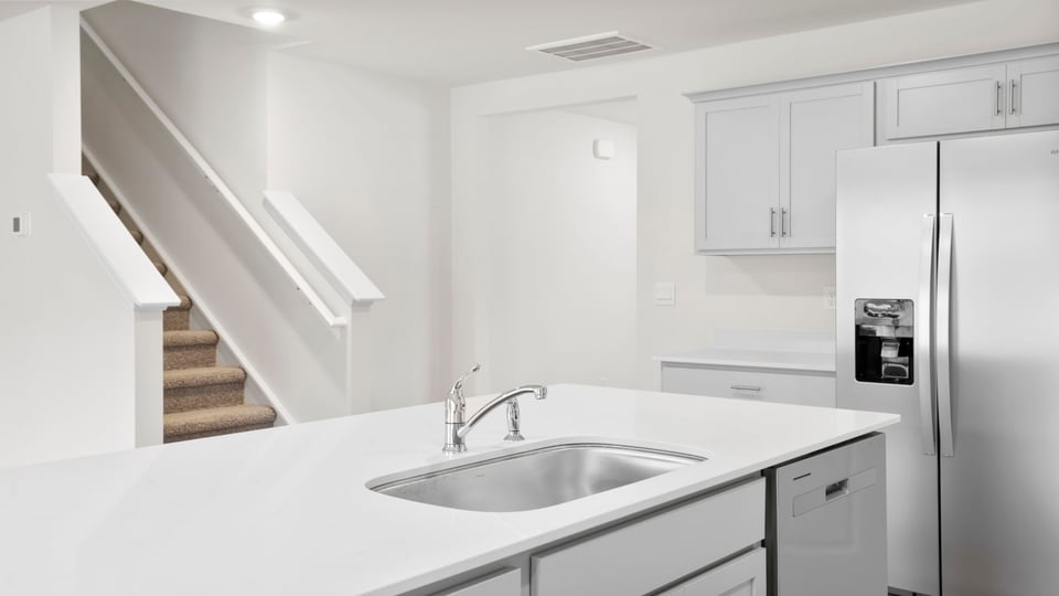 Kitchen and island with quartz countertops.