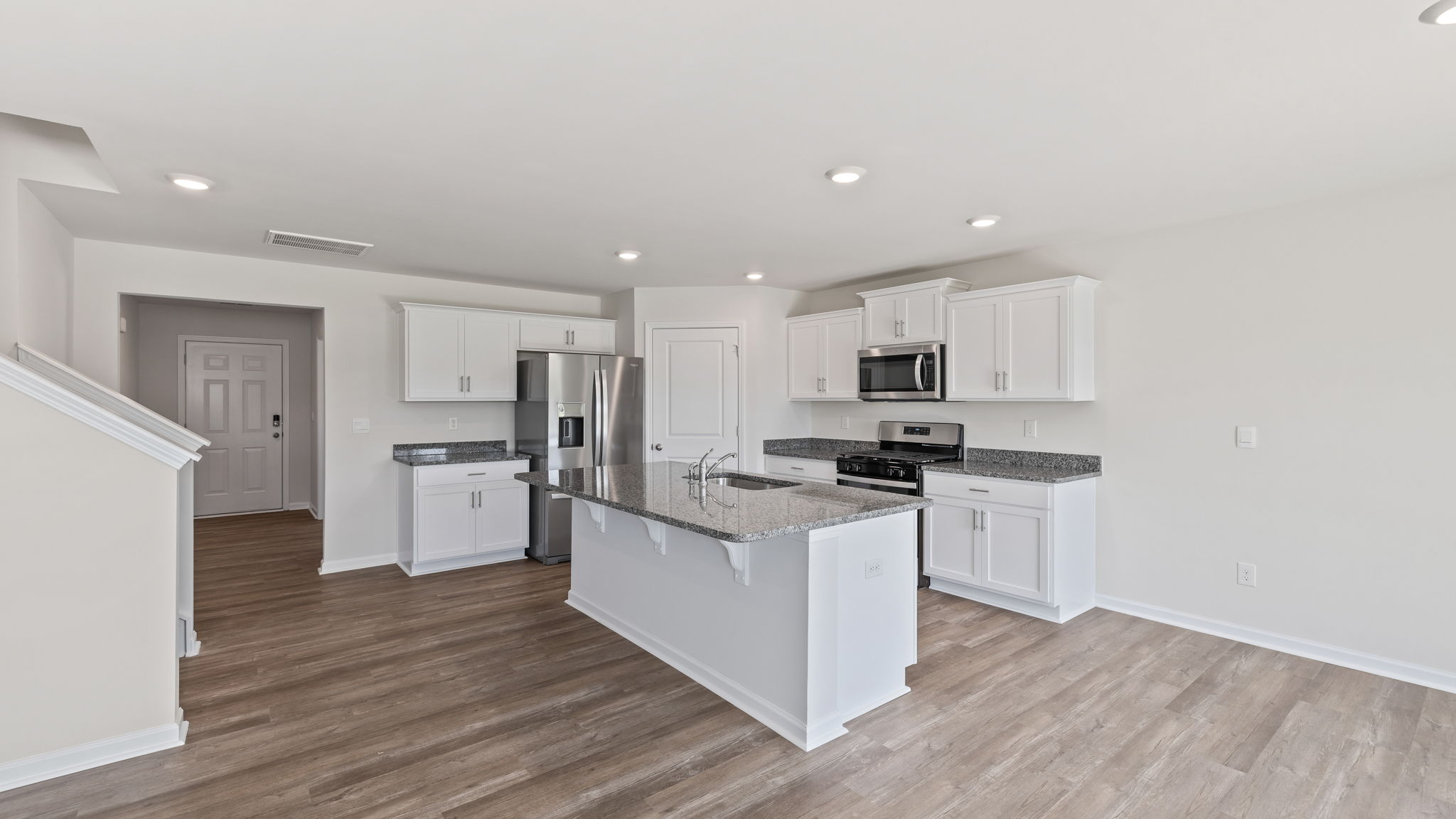 View of kitchen and hallway to entrance.