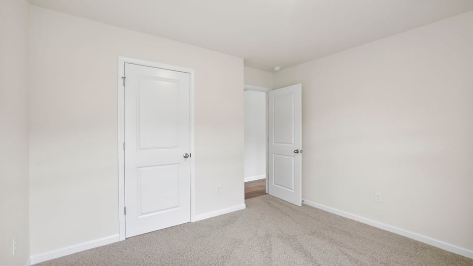 Bedroom with carpet and window.