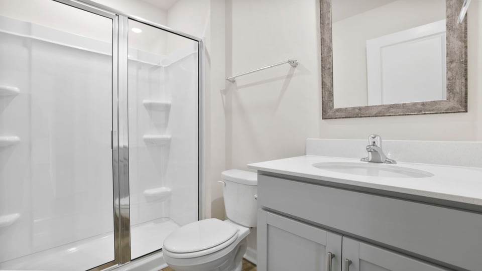 Bathroom with walk in shower and single vanity sink.