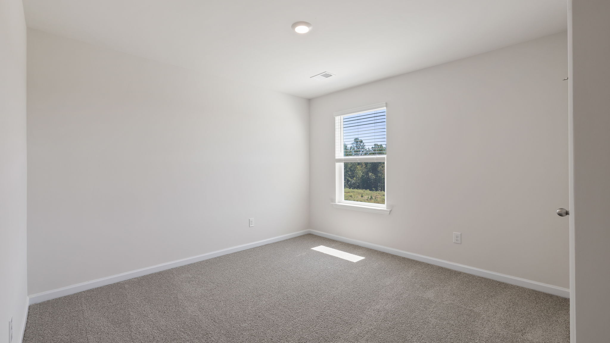 Bedroom with window and carpet.