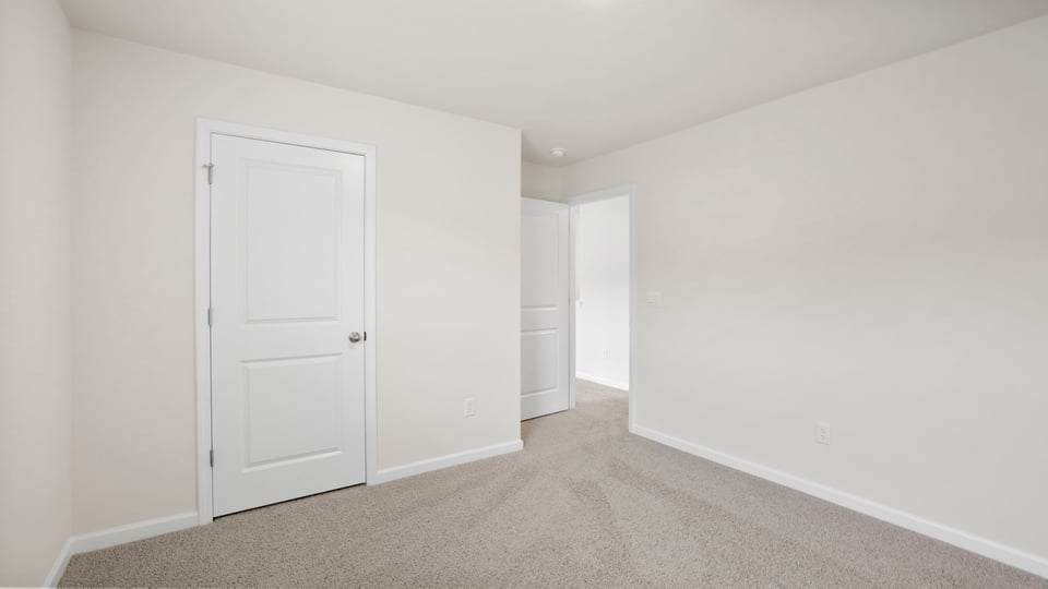 Bedroom with carpet and window.