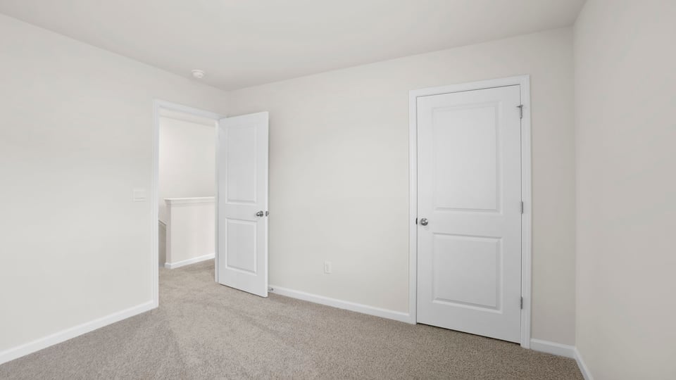 Bedroom with carpet and window.