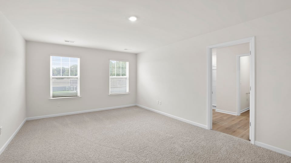 Bedroom with carpet and window.