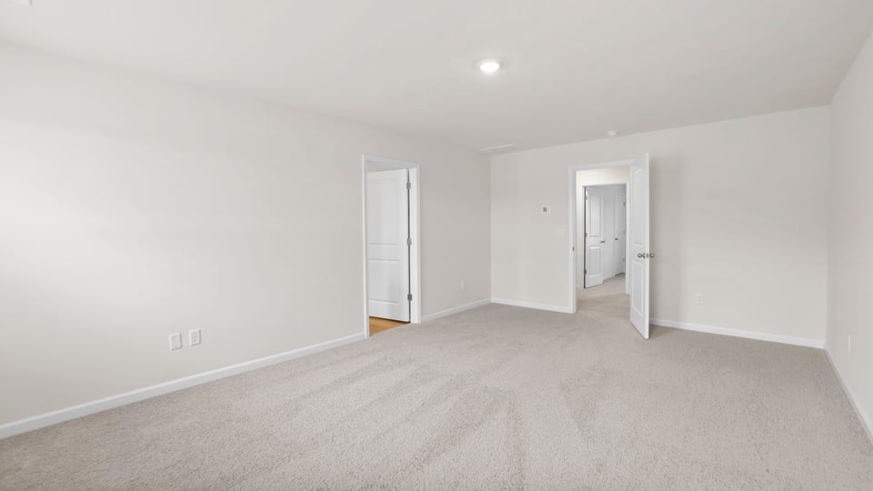 Bedroom with carpet and window.