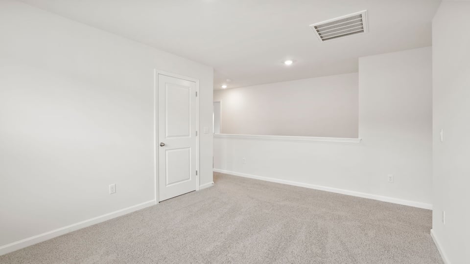 Bedroom with carpet and window.a