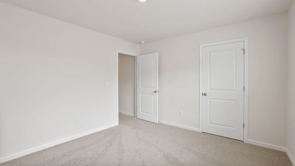 Bedroom with carpet and window.