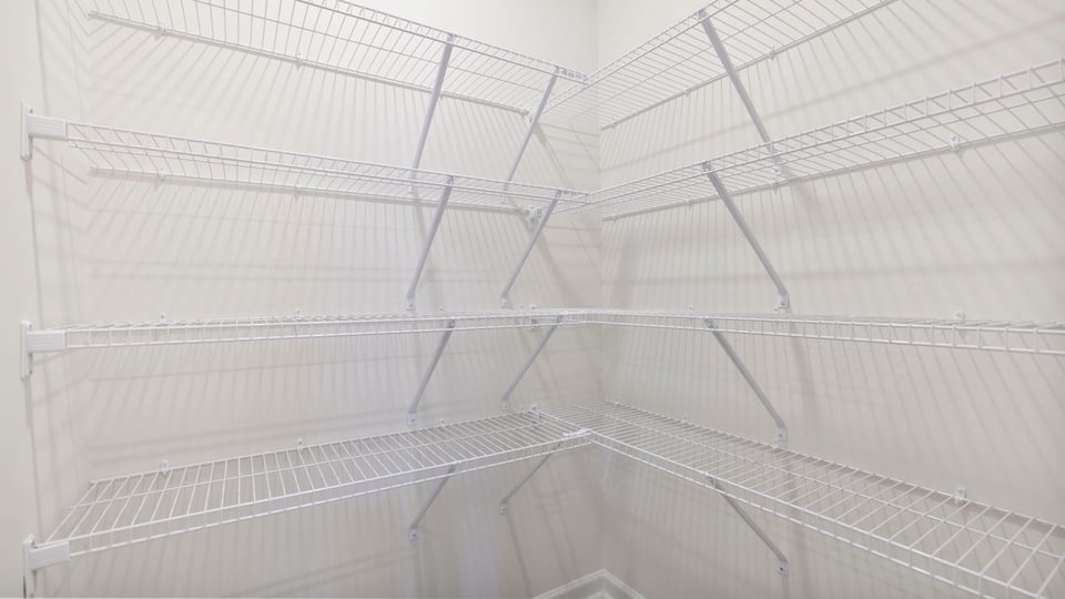 Closet with hanging storage racks.