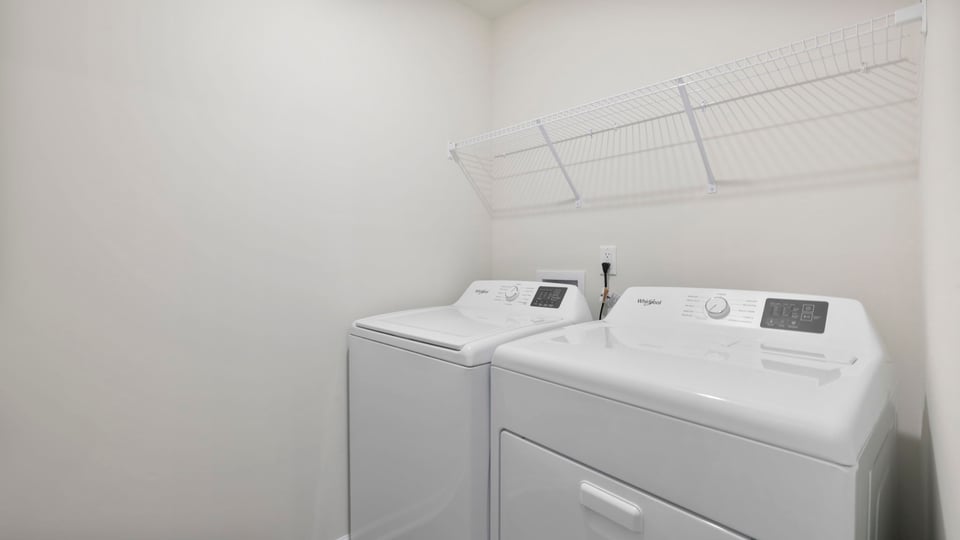 Laundry room with hanging storage racks.