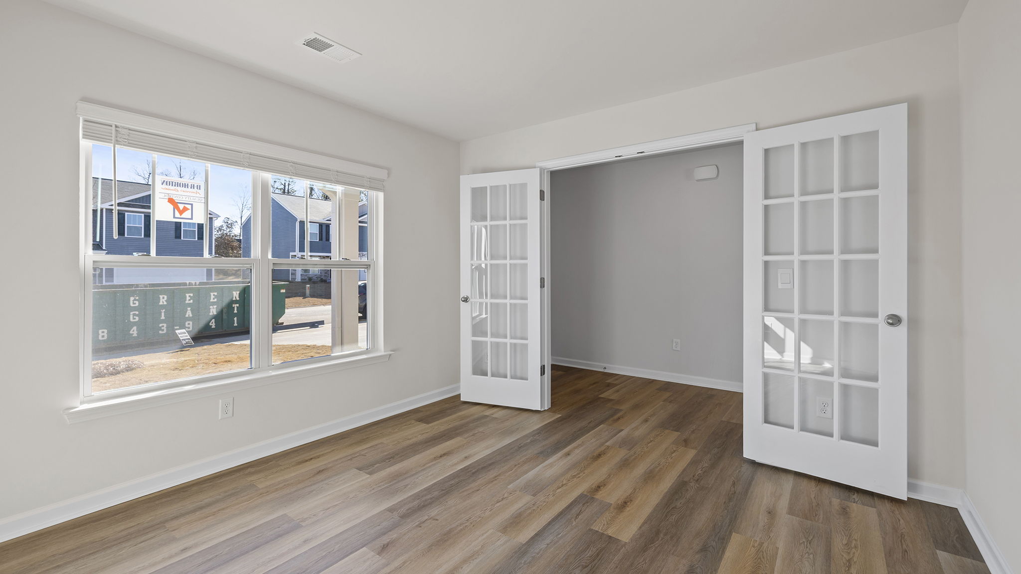 Study with windows and accented by French doors.