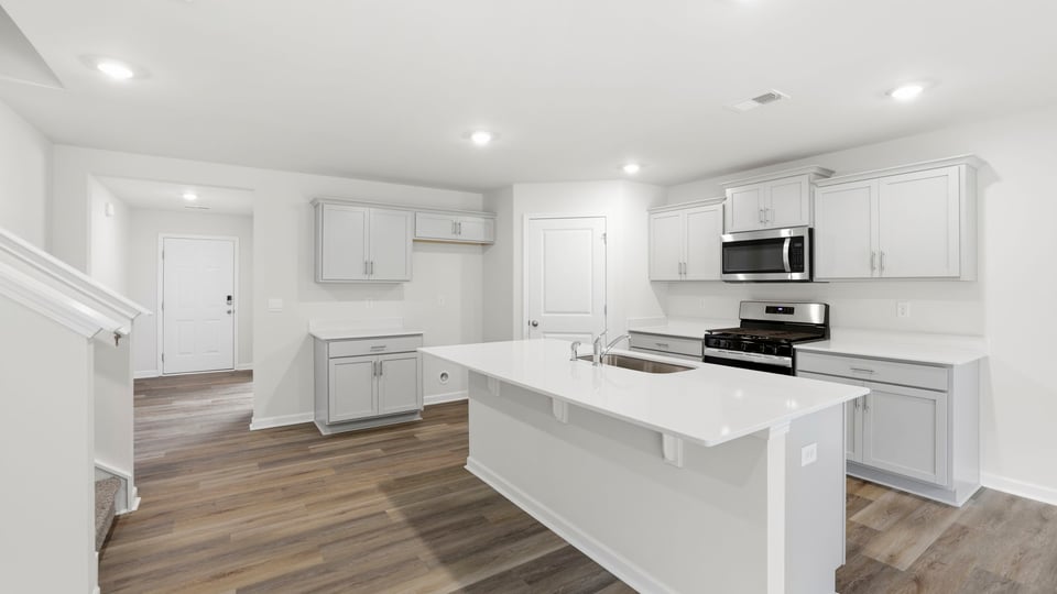 Kitchen and island with quartz countertops.a