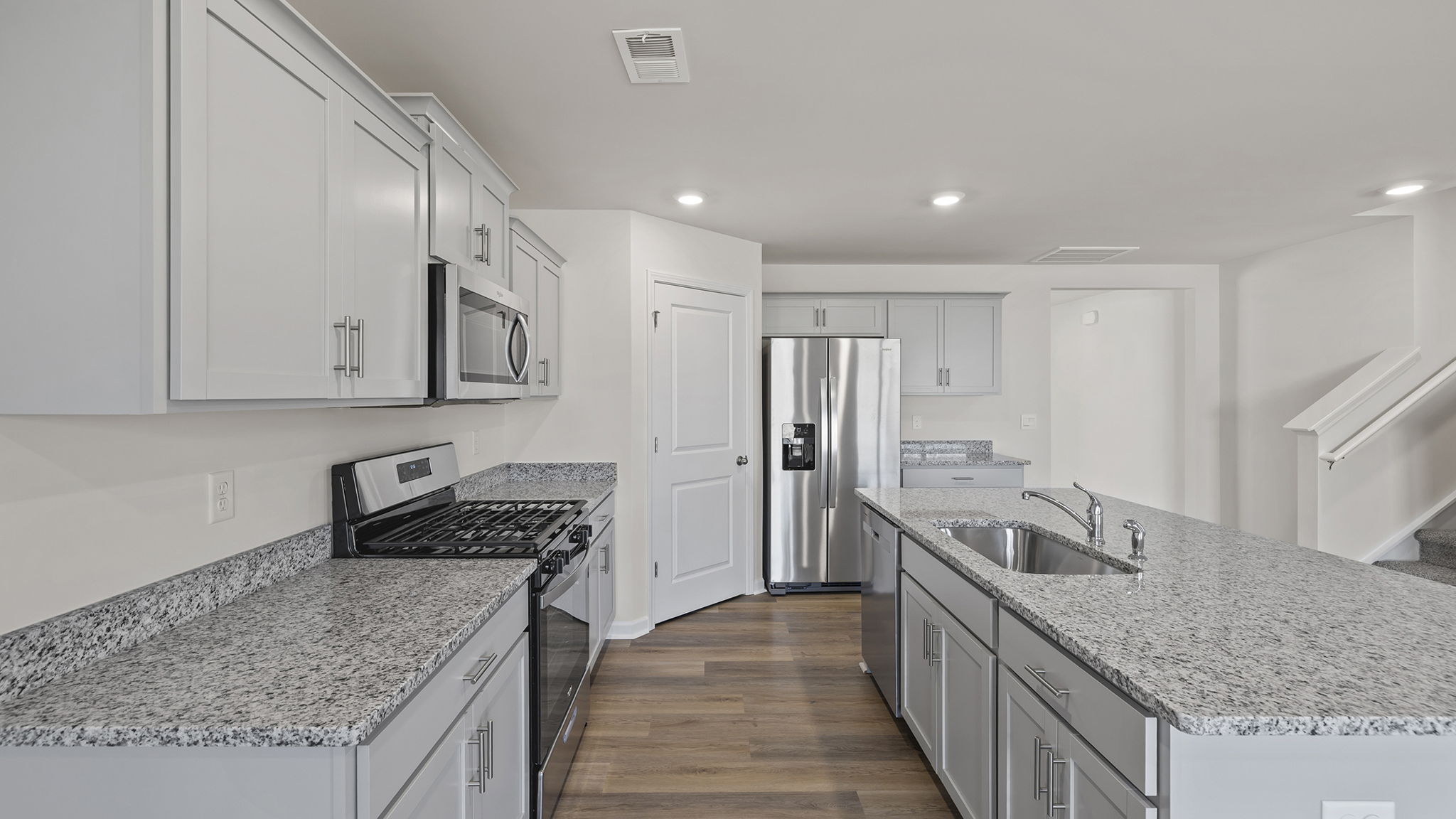 Kitchen and island have quartz countertops.