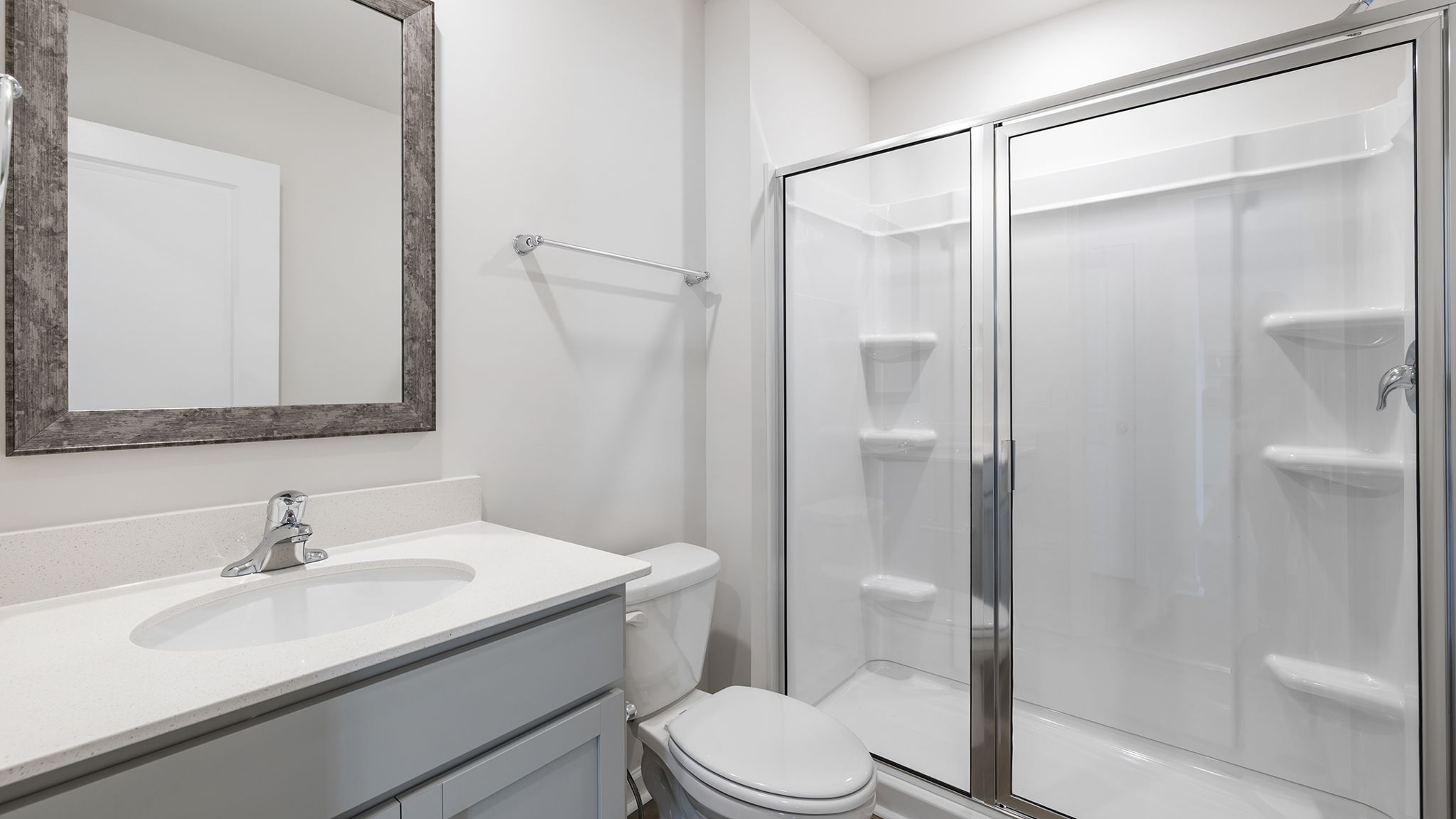 Full bathroom on the main level with vanity and walk-in shower.